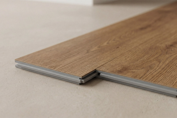 A detailed close-up showing the interlocking mechanism and high-resolution wood grain texture of a premium hybrid flooring plank